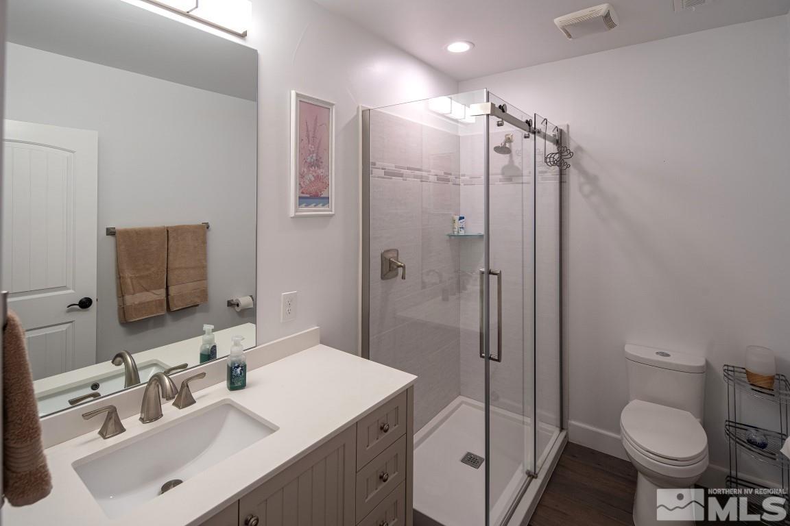 4610 Tybo Road Reno, NV 89521 - Photo 34 of 40 a bathroom with a sink toilet vanity and shower
