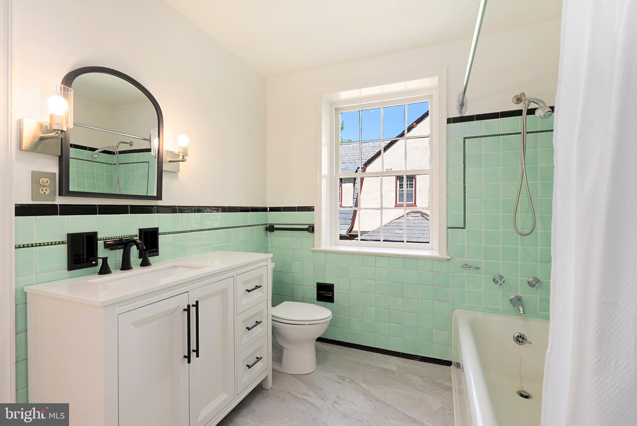 602 Stoneleigh Road Baltimore, MD 21212 - Photo 16 of 31 a bathroom with a toilet sink and mirror