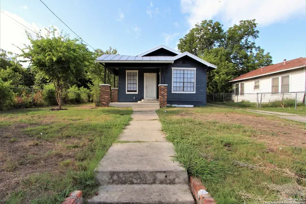 a front view of a house with yard and green space
