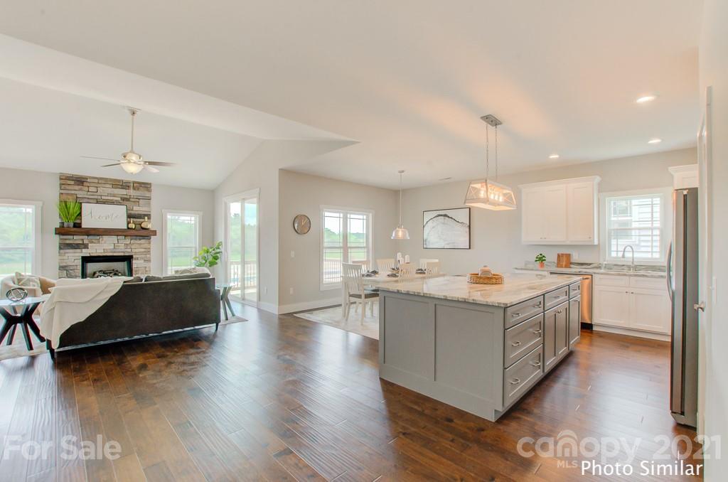 235 Hayes Rdg Lane, Unit 14 Mills River, NC 28759 - Photo 5 of 18 a kitchen with a sink stove and wooden floor