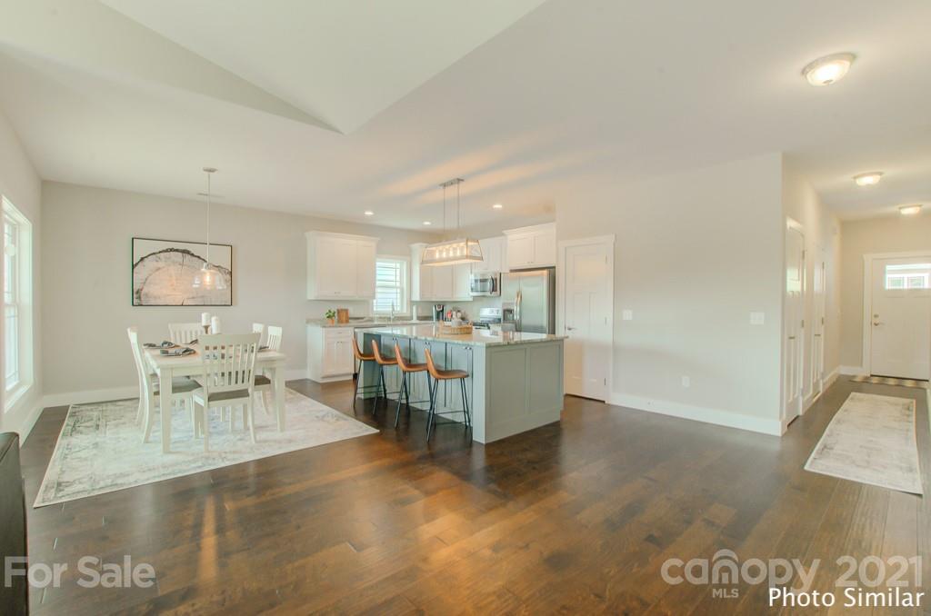 235 Hayes Rdg Lane, Unit 14 Mills River, NC 28759 - Photo 7 of 18 a living room with furniture and a dining table with wooden floor