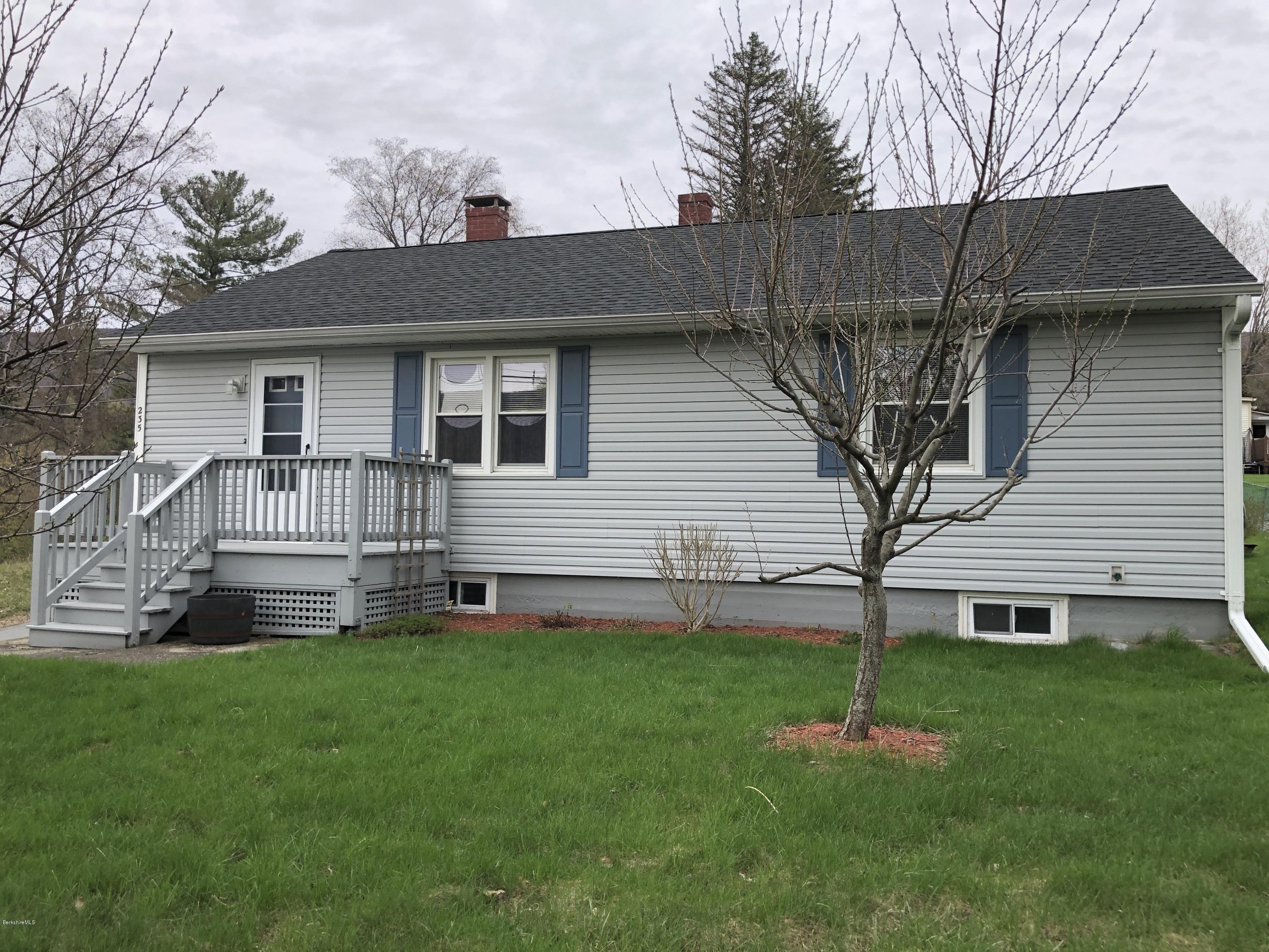 a front view of house with a garden