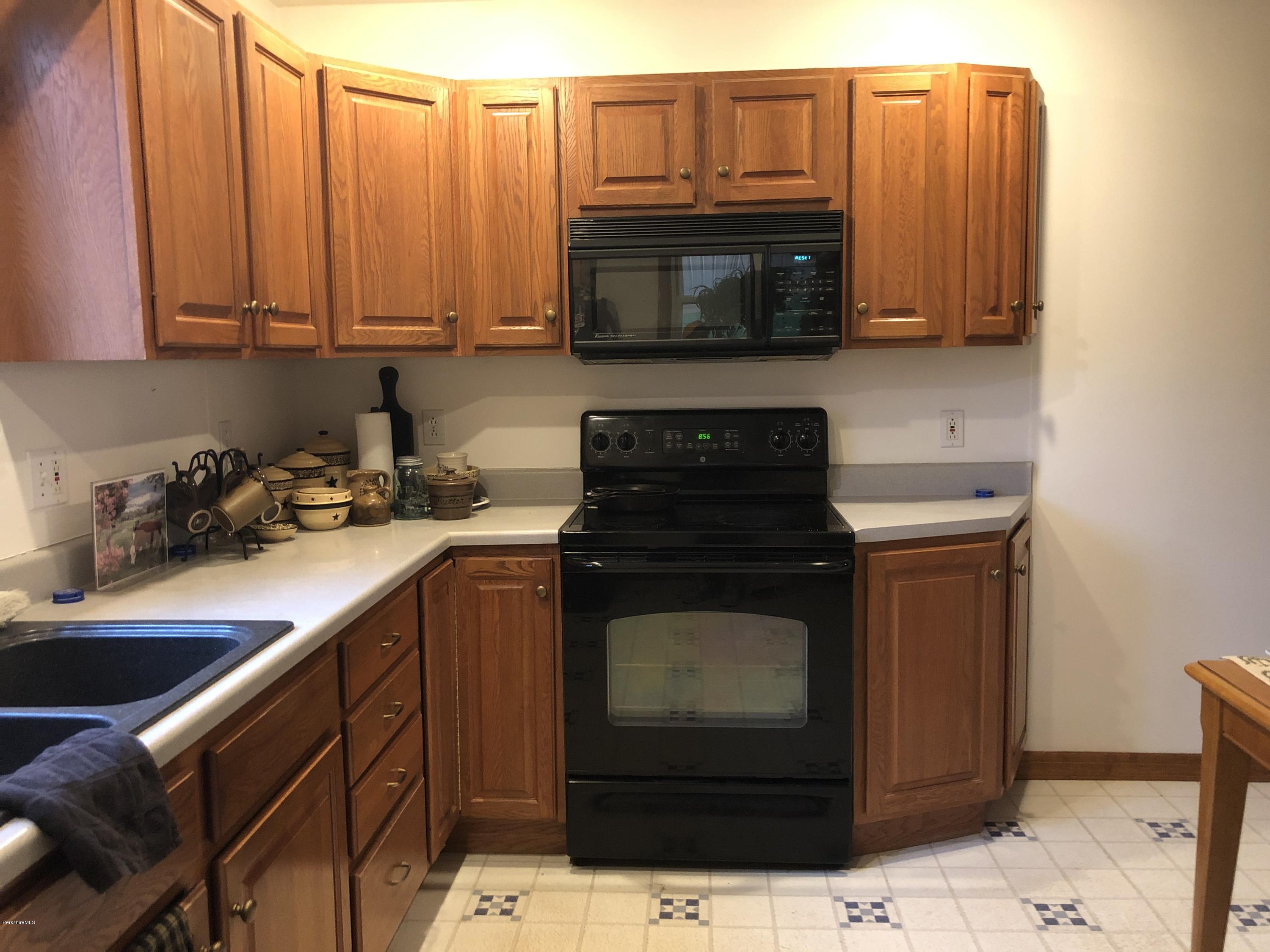 235 East Road Adams, MA 01220 - Photo 5 of 15 a kitchen with stainless steel appliances a stove a microwave and sink