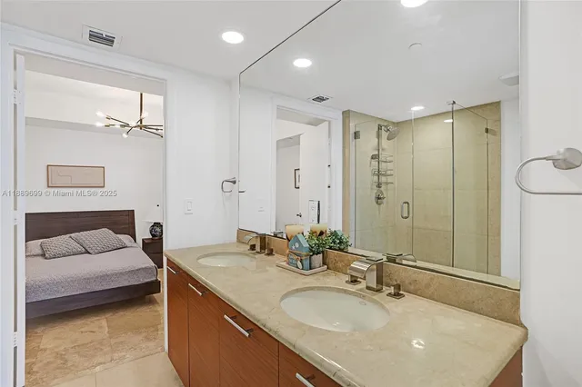 a bathroom with a sink double vanity and a mirror