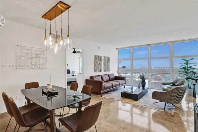 a view of a dining room with furniture and chandelier