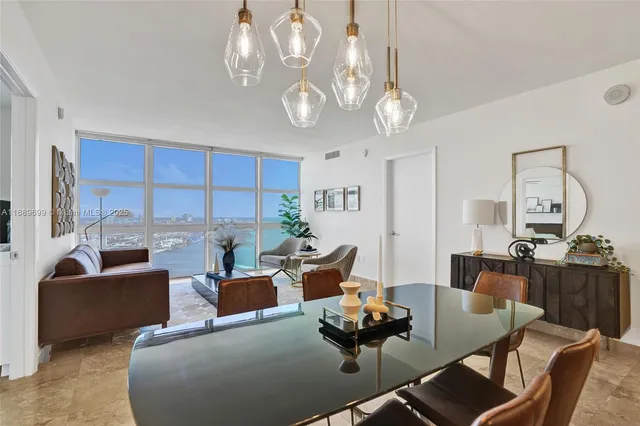 a living room with furniture or kitchen and a chandelier