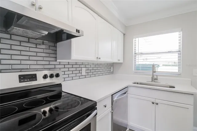 a kitchen with a stove microwave and sink
