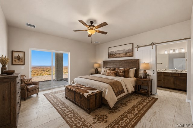 9818 North Cyrus Road Kingman, AZ 86401 - Photo 7 of 42 a bedroom with a large bed and a chandelier