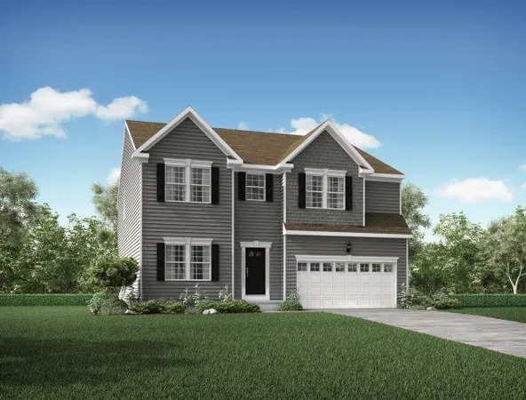 a front view of a house with a garden and yard