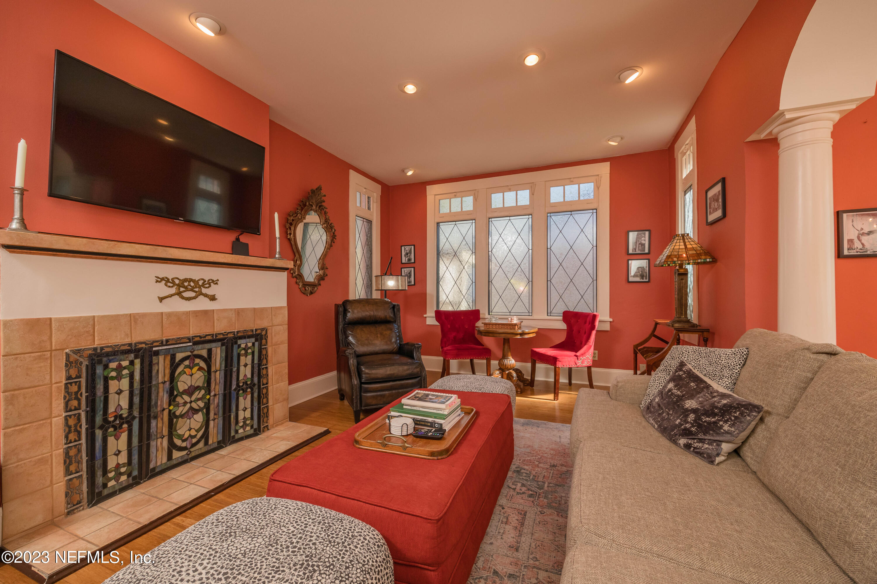 16 May Street St. Augustine, FL 32084 - Photo 17 of 86 a living room with furniture a flat screen tv and a fireplace