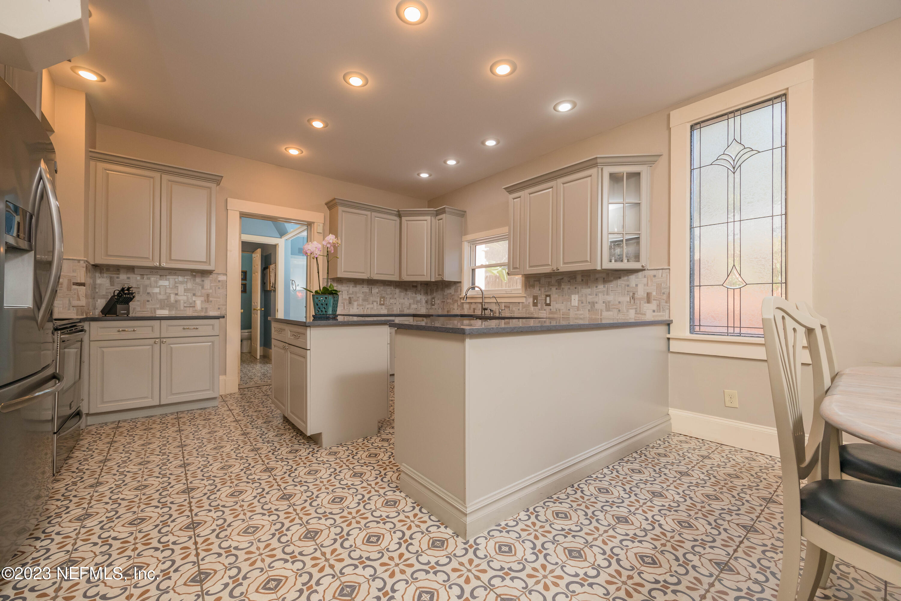 16 May Street St. Augustine, FL 32084 - Photo 25 of 86 a kitchen with a refrigerator and white cabinets