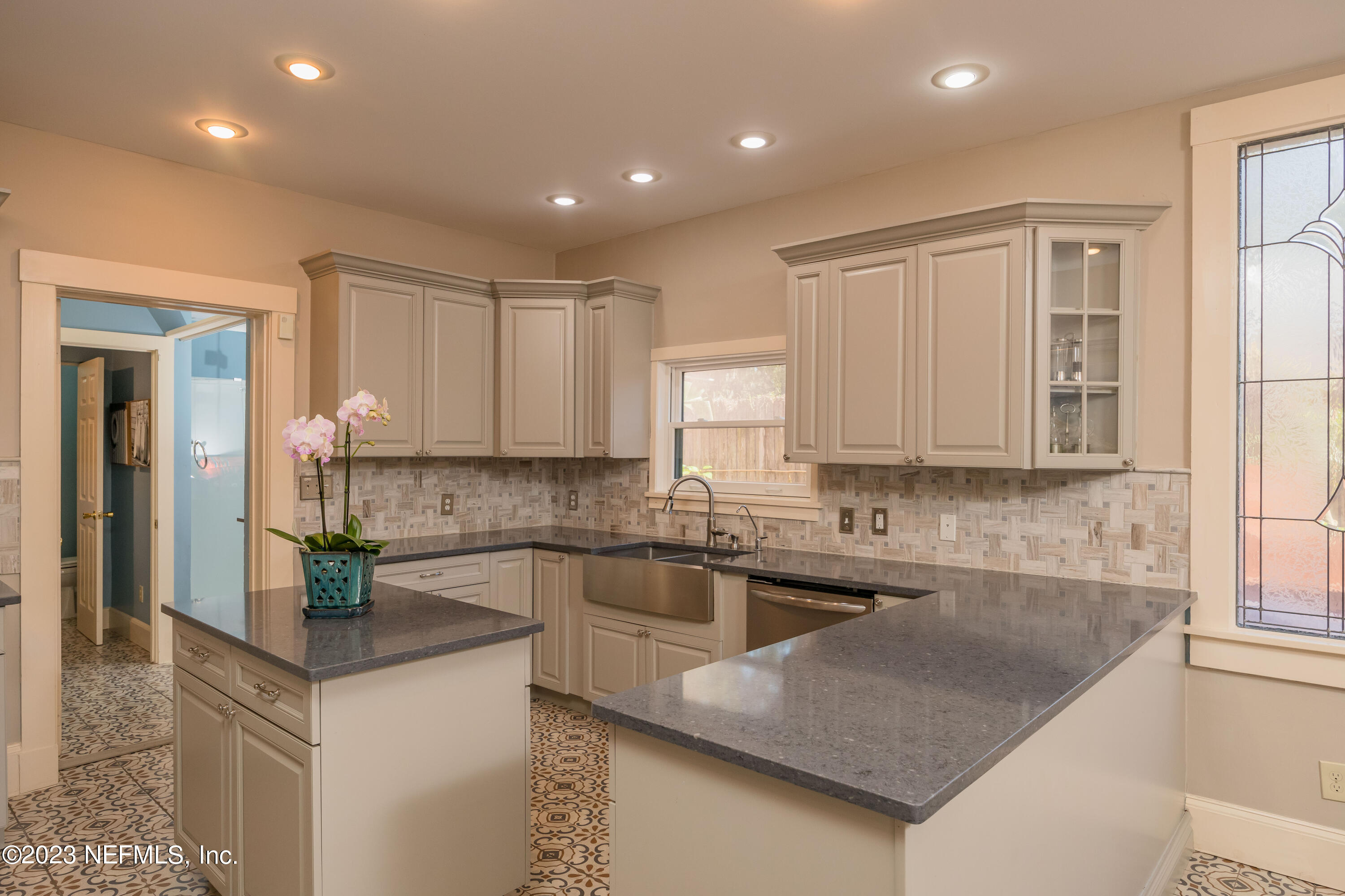 16 May Street St. Augustine, FL 32084 - Photo 26 of 86 a kitchen with stainless steel appliances granite countertop a sink a stove and a refrigerator
