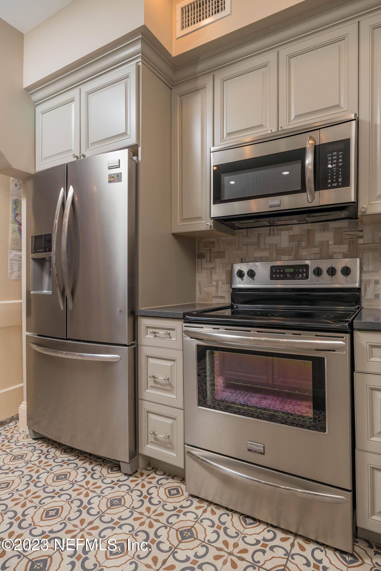 16 May Street St. Augustine, FL 32084 - Photo 27 of 86 a kitchen with granite countertop a stove microwave and fridge