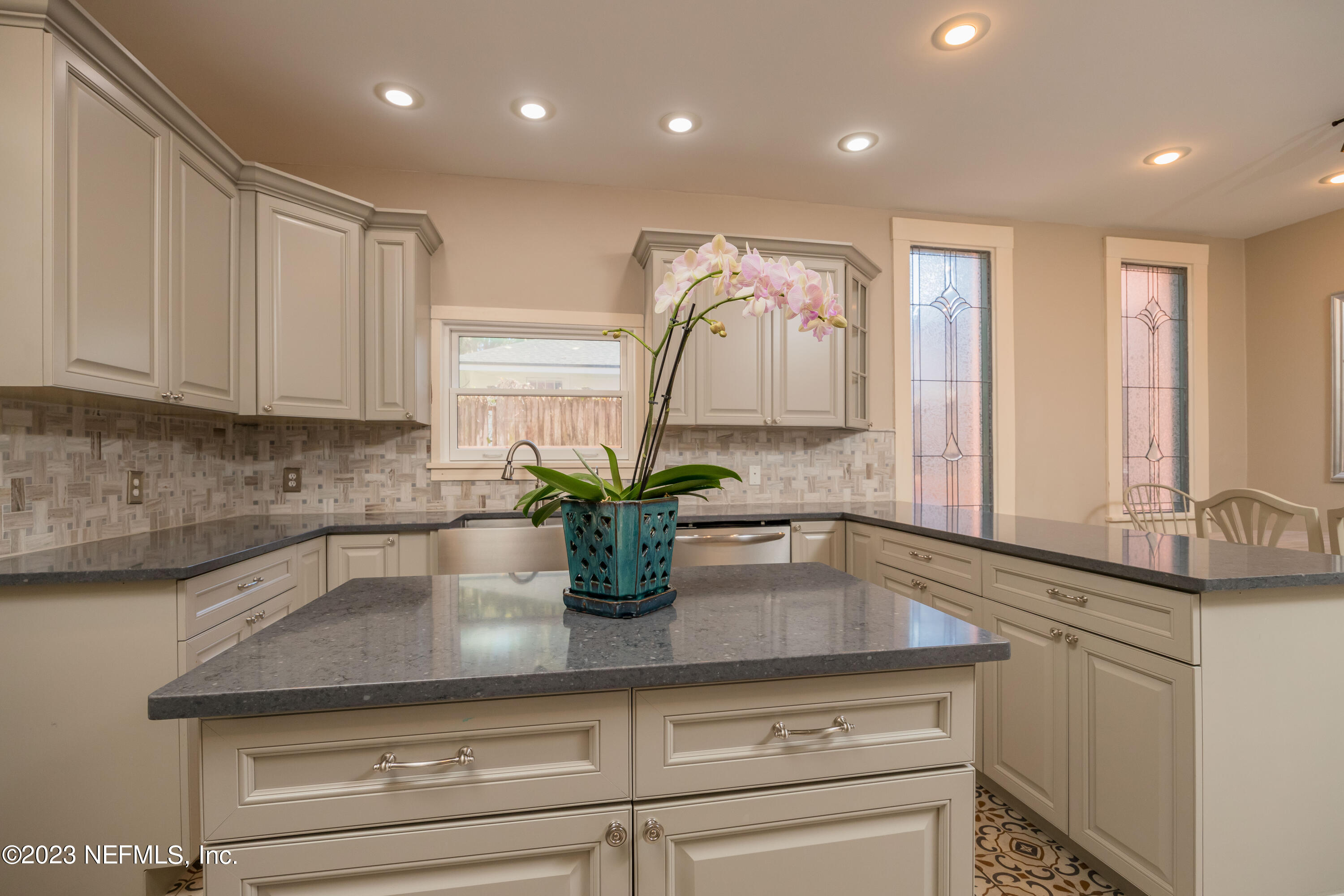 16 May Street St. Augustine, FL 32084 - Photo 28 of 86 a kitchen with sink a potted plant and cabinets