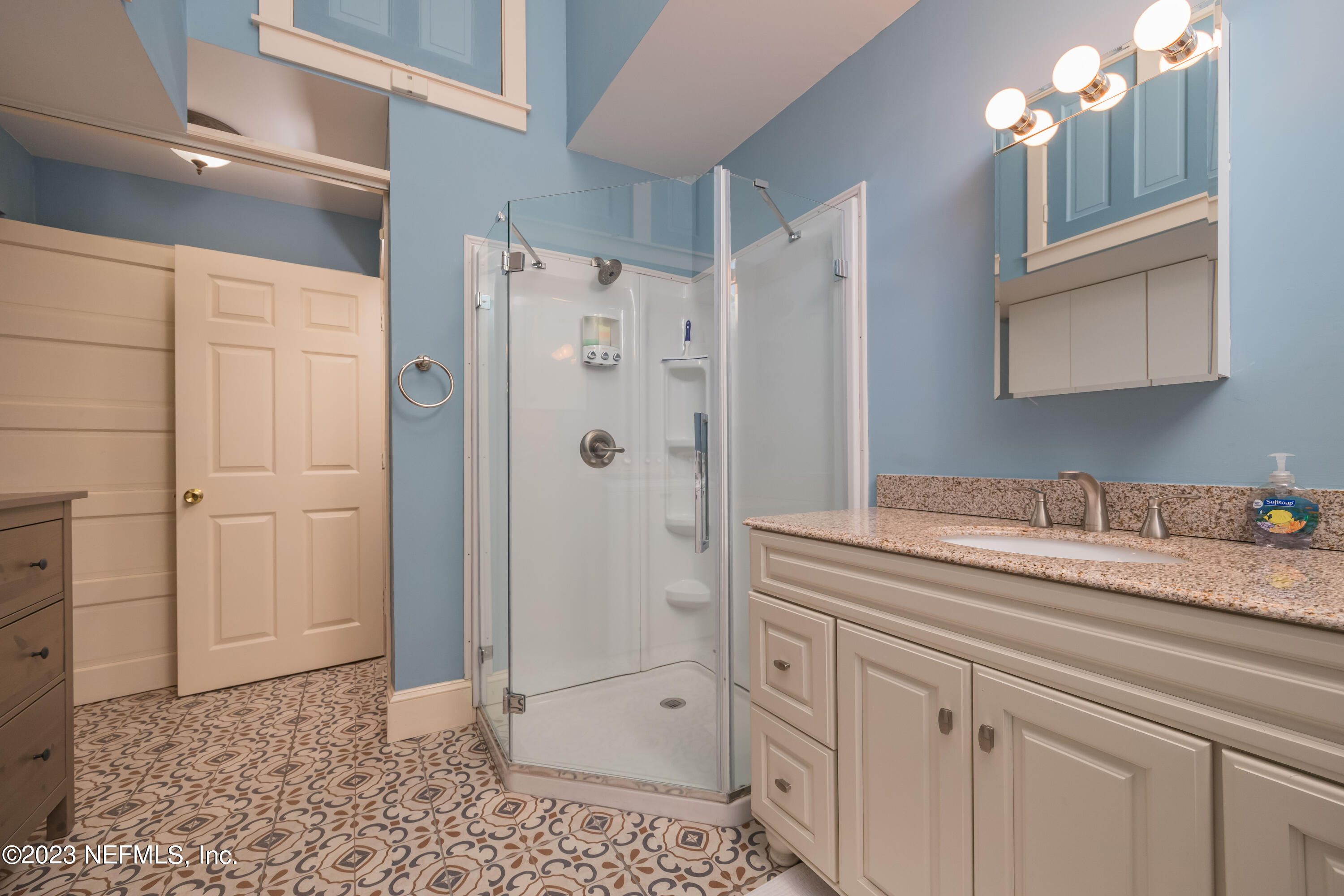 16 May Street St. Augustine, FL 32084 - Photo 33 of 86 a spacious bathroom with a granite countertop sink a mirror and shower
