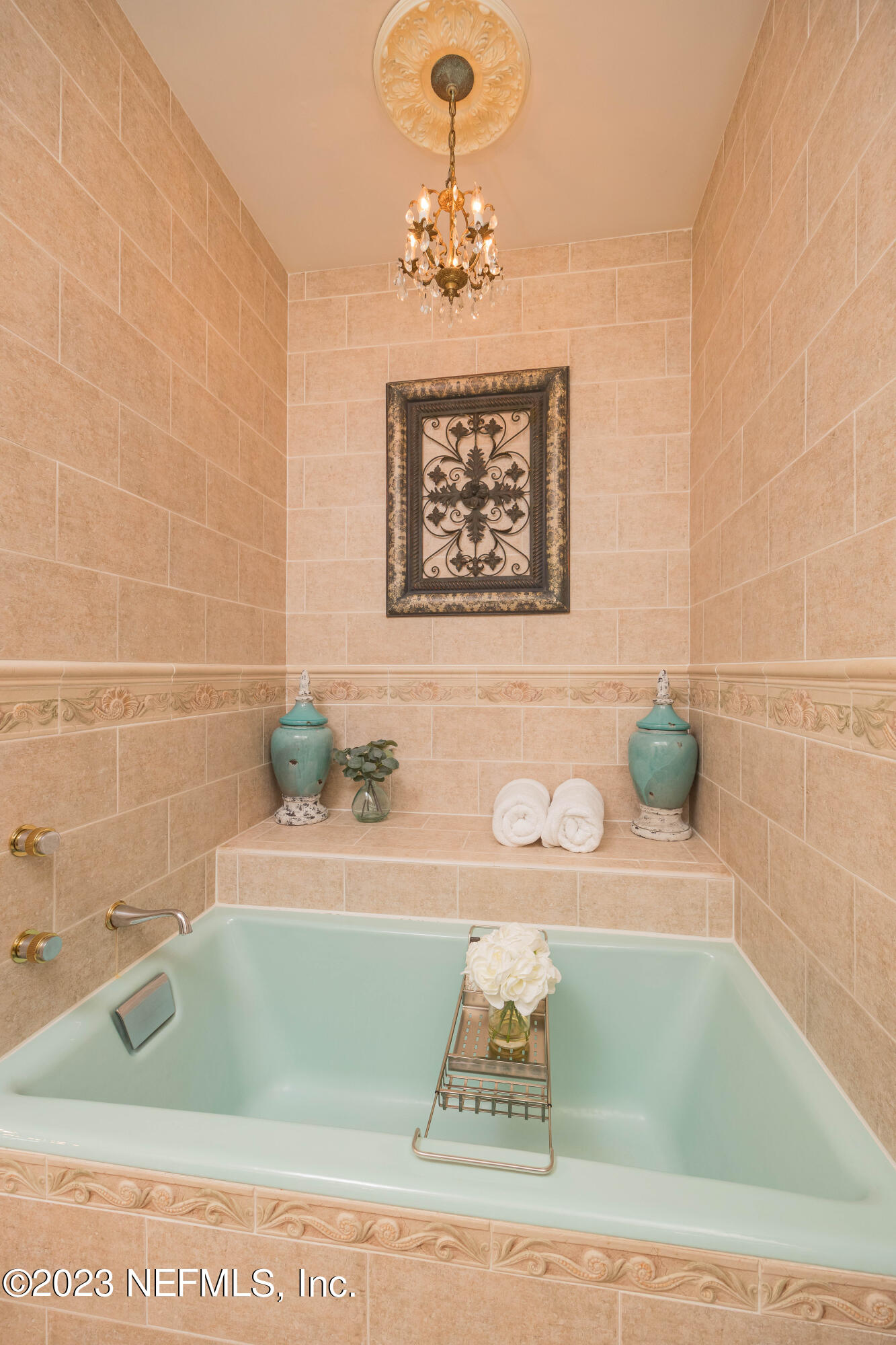 16 May Street St. Augustine, FL 32084 - Photo 50 of 86 a bathroom with a sink a mirror and a bathtub