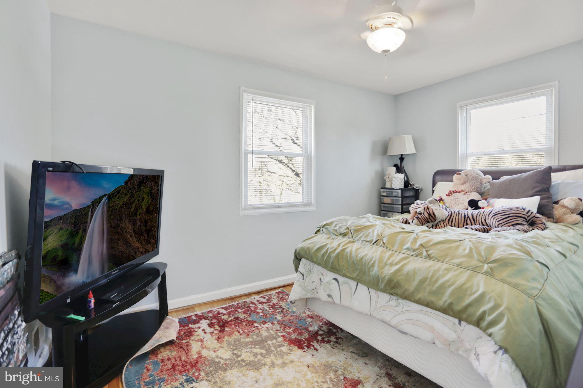 4910 Sargent Road Northeast Washington, DC 20017 - Photo 10 of 16 a bed room with a bed a television and dresser