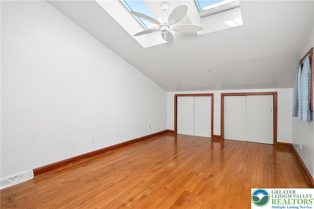 120 Royal Manor Road Easton, PA 18042 - Photo 21 of 49 an empty room with wooden floor fan and windows