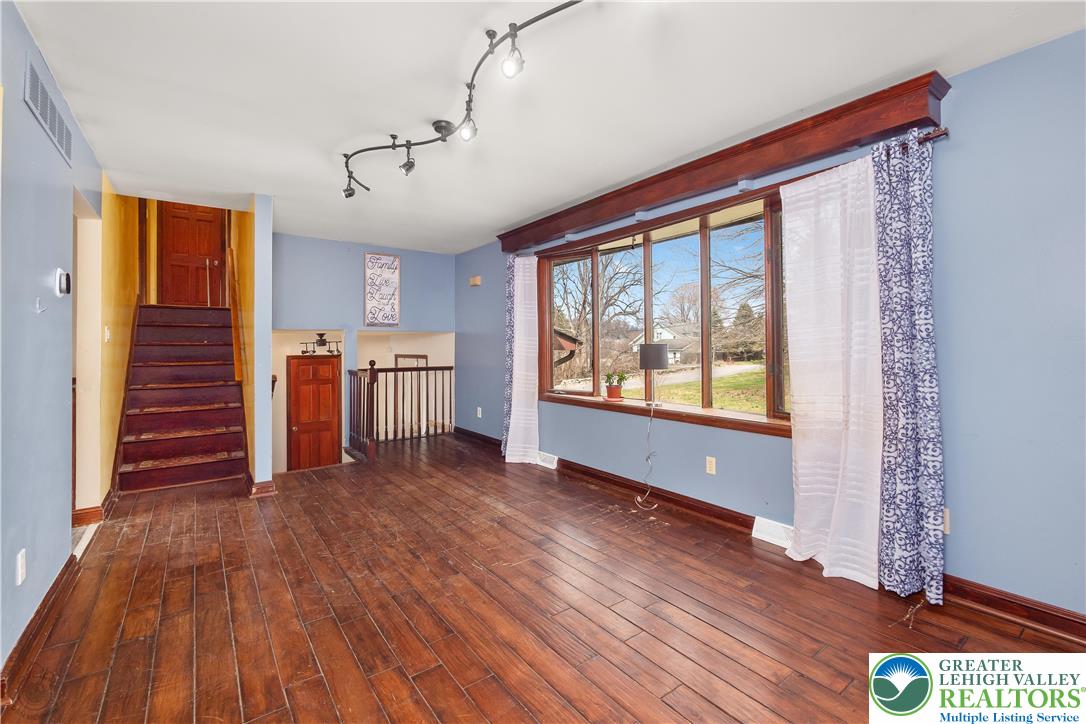 120 Royal Manor Road Easton, PA 18042 - Photo 5 of 49 a view of an empty room with window wooden floor and a kitchen