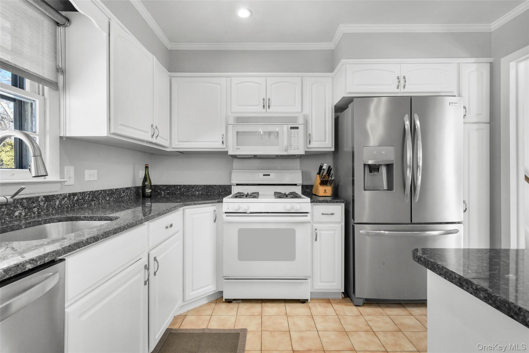 46 Harding Drive New Rochelle, NY 10801 - Photo 11 of 31 a kitchen with a refrigerator sink and cabinets