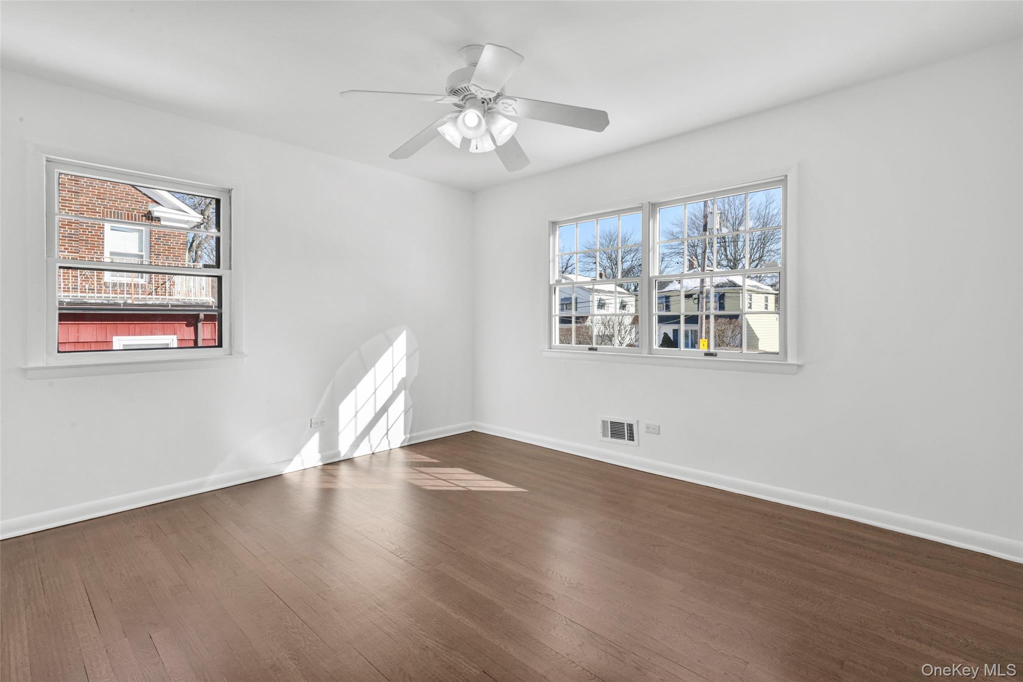 46 Harding Drive New Rochelle, NY 10801 - Photo 19 of 31 a view of an empty room with wooden floor and a window