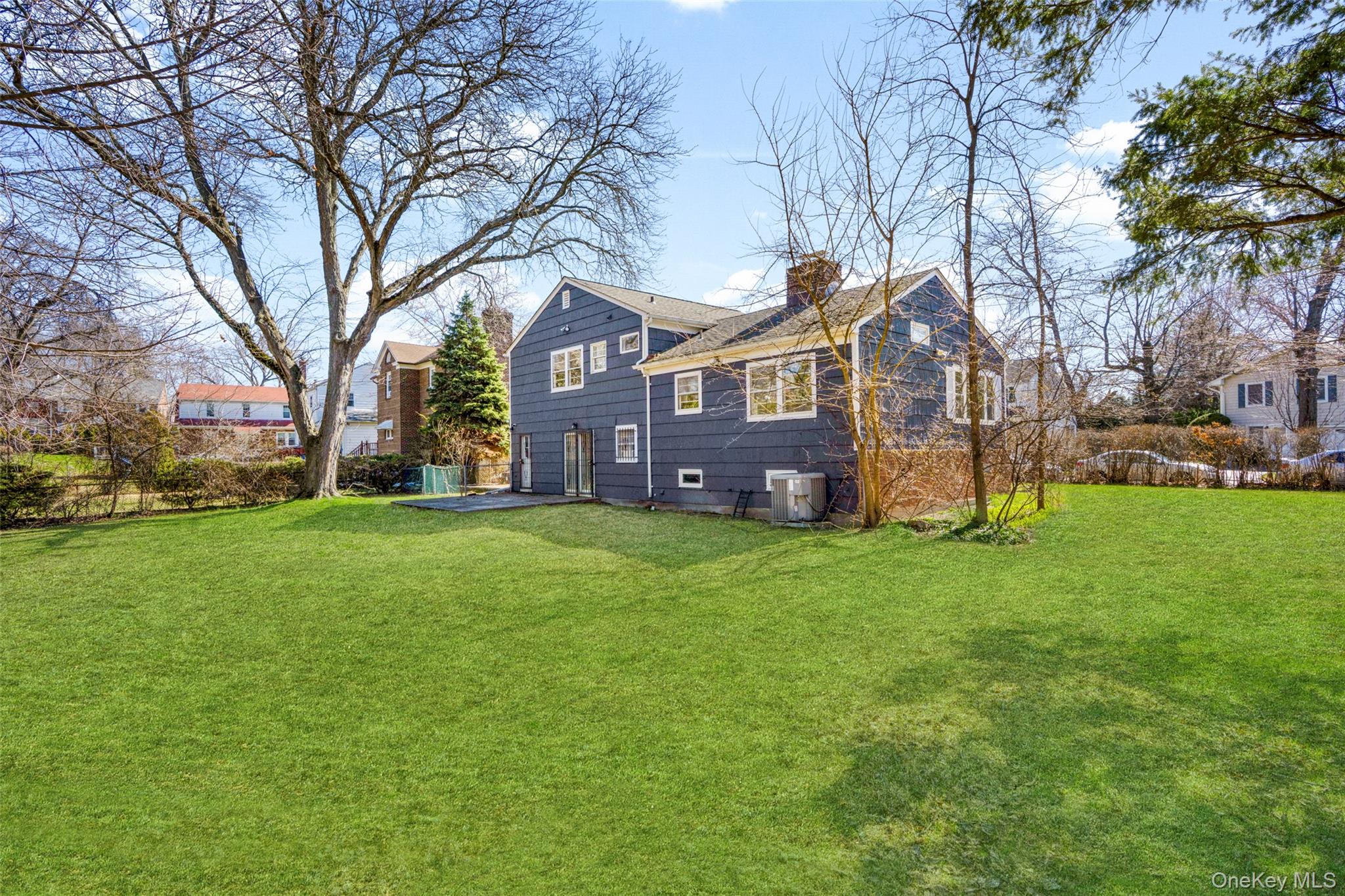 46 Harding Drive New Rochelle, NY 10801 - Photo 28 of 31 a front view of house with yard and green space