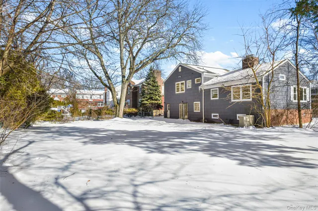 a view of a house with a yard covered in snow