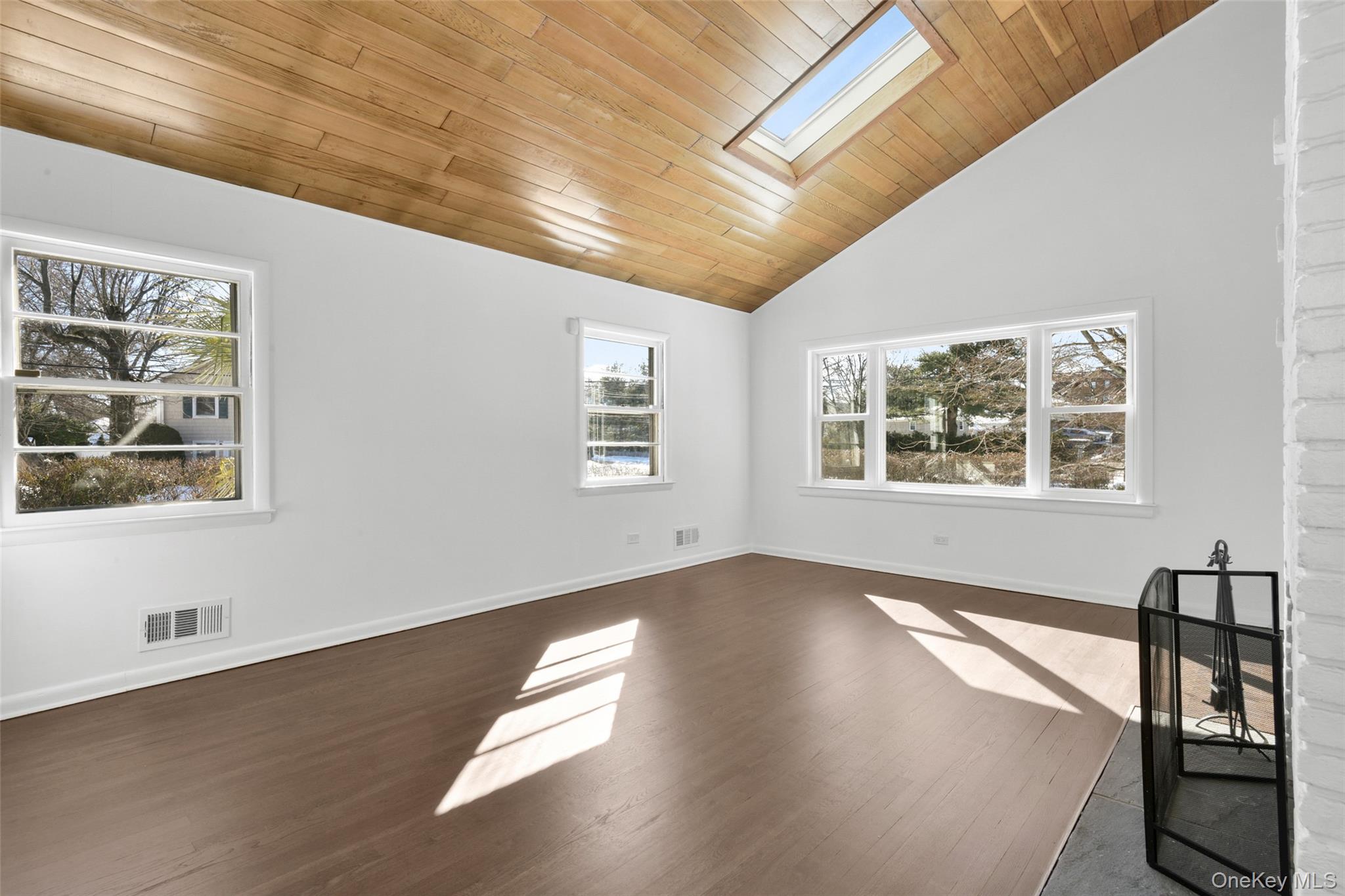 46 Harding Drive New Rochelle, NY 10801 - Photo 6 of 31 a view of an empty room with wooden floor and a window