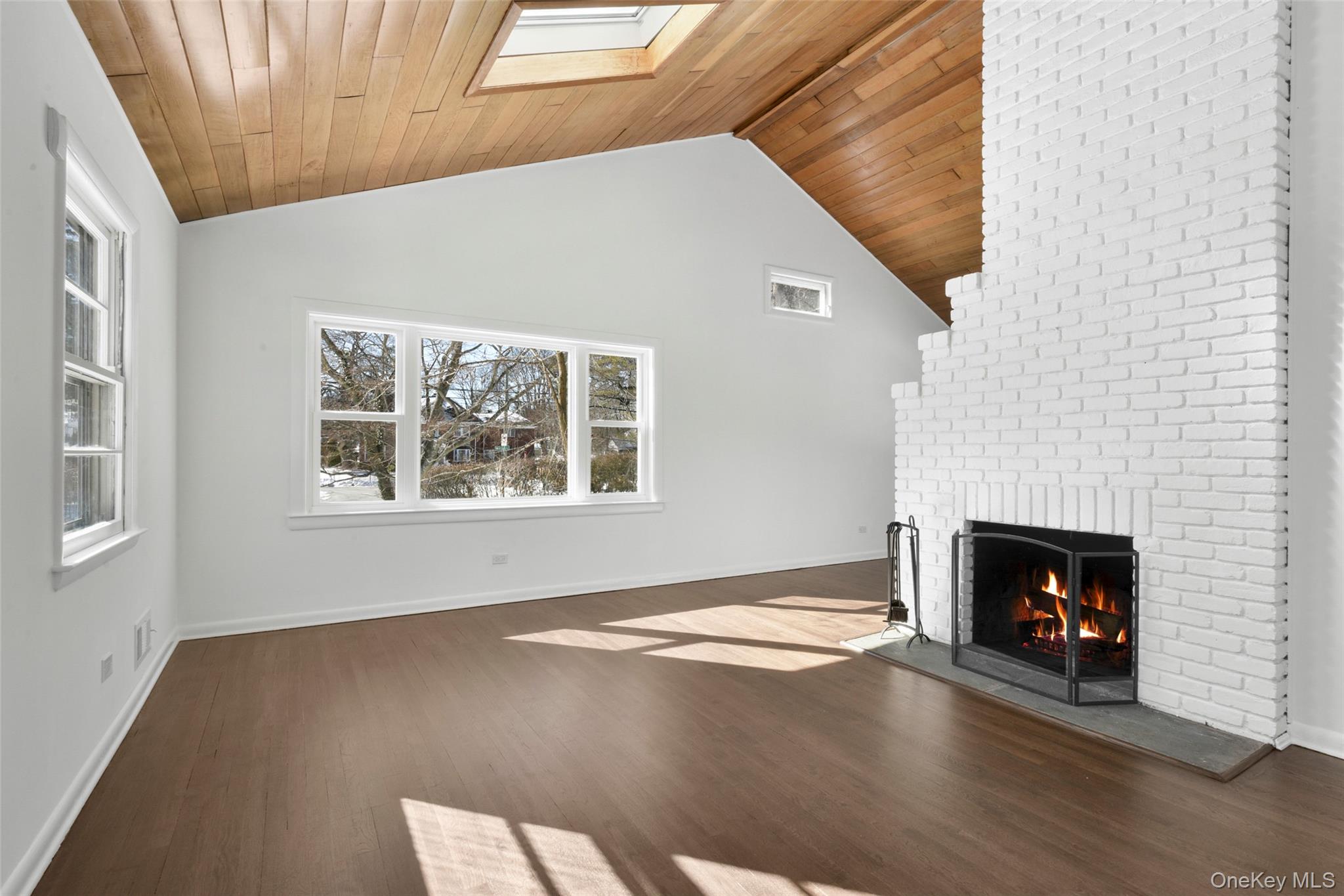 46 Harding Drive New Rochelle, NY 10801 - Photo 7 of 31 a view of an empty room with wooden floor fireplace and a window