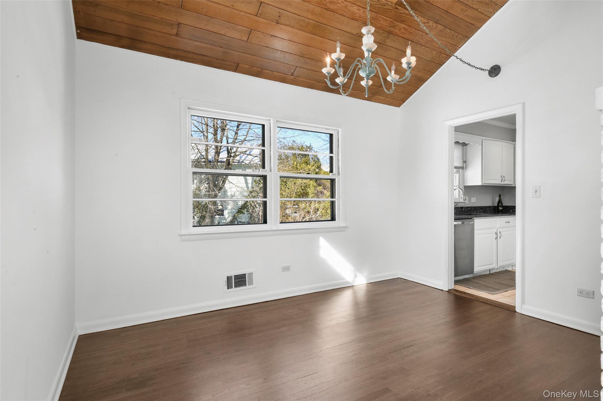 46 Harding Drive New Rochelle, NY 10801 - Photo 10 of 31 an empty room with wooden floor cabinet and windows