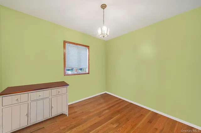 a view of a room with wooden floor and ceiling fan