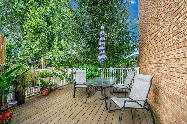 a view of a chairs and table on the wooden deck
