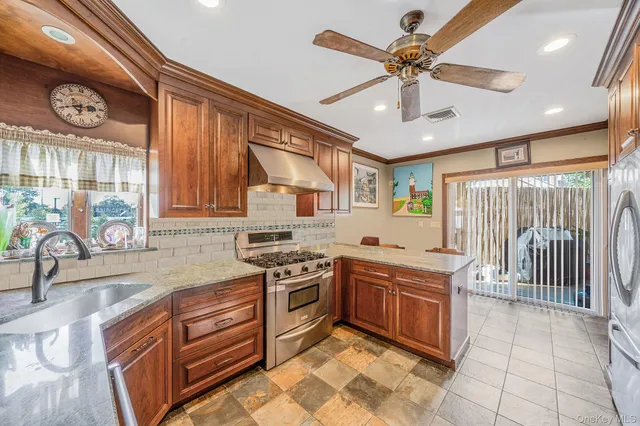 a kitchen with stainless steel appliances granite countertop a sink and cabinets