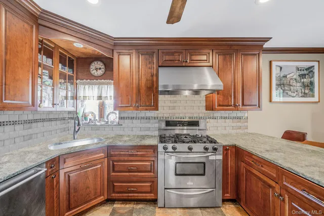 a kitchen with stainless steel appliances a stove and a sink