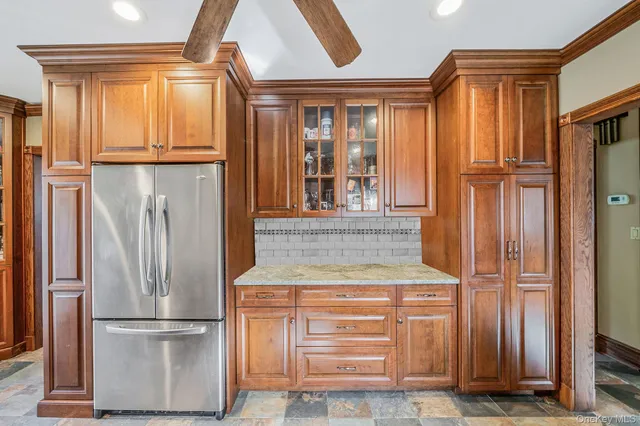 a kitchen with stainless steel appliances granite countertop a refrigerator and a sink