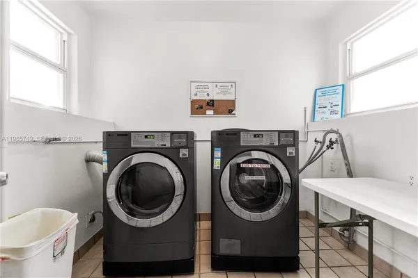 a utility room with sink dryer and washer