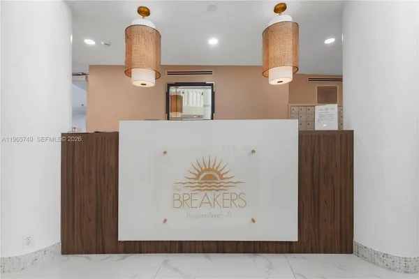 a view of kitchen with a sink and a mirror