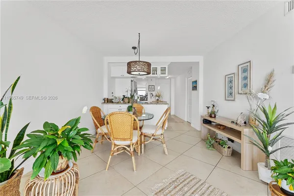 a dining room with furniture and a chandelier