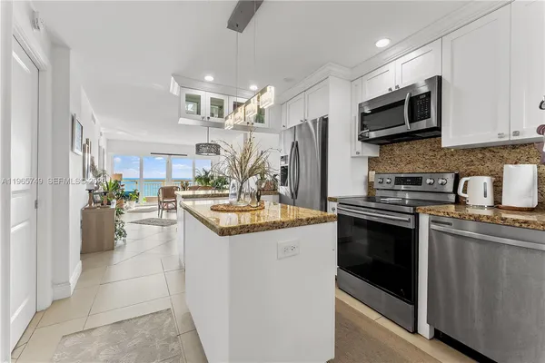 a kitchen with stainless steel appliances a stove refrigerator sink and microwave