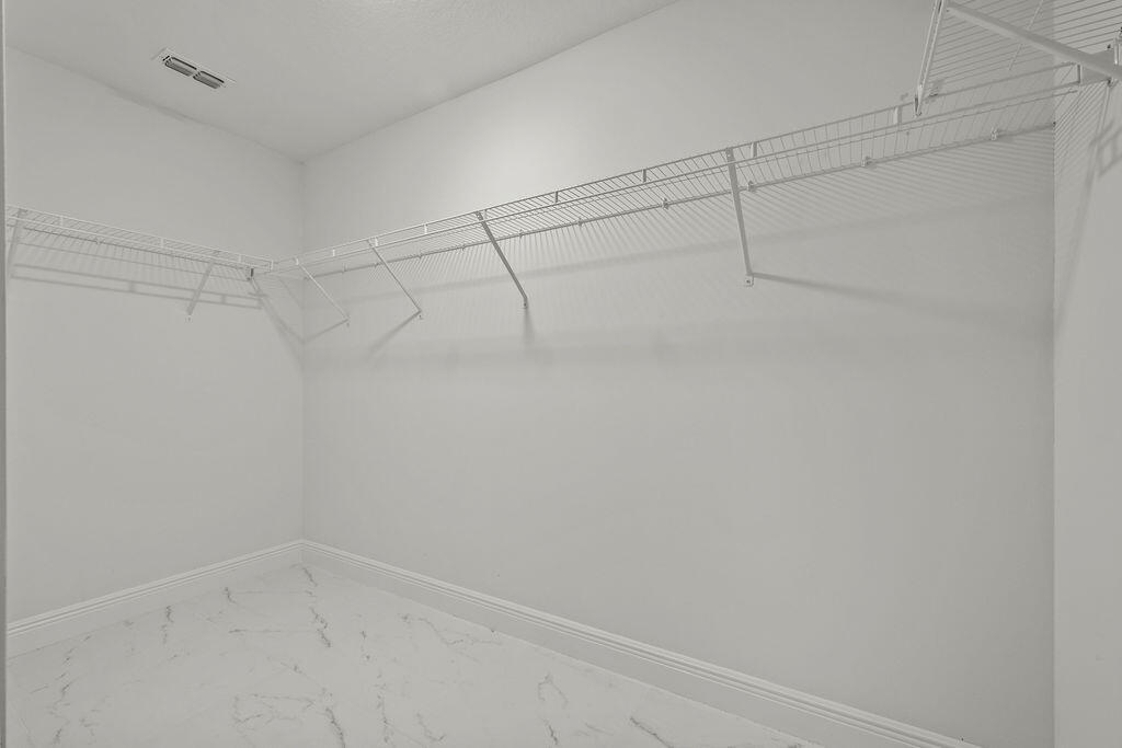 362 Northwest Bayshore Boulevard Port St. Lucie, FL 34983 - Photo 11 of 32 a view of a room with racks on the wall