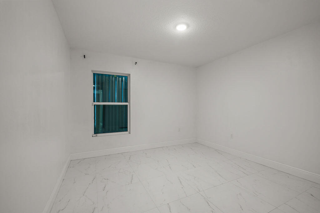 362 Northwest Bayshore Boulevard Port St. Lucie, FL 34983 - Photo 14 of 32 an empty room with a window and closet