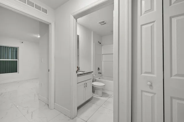 a bathroom with a toilet sink and shower
