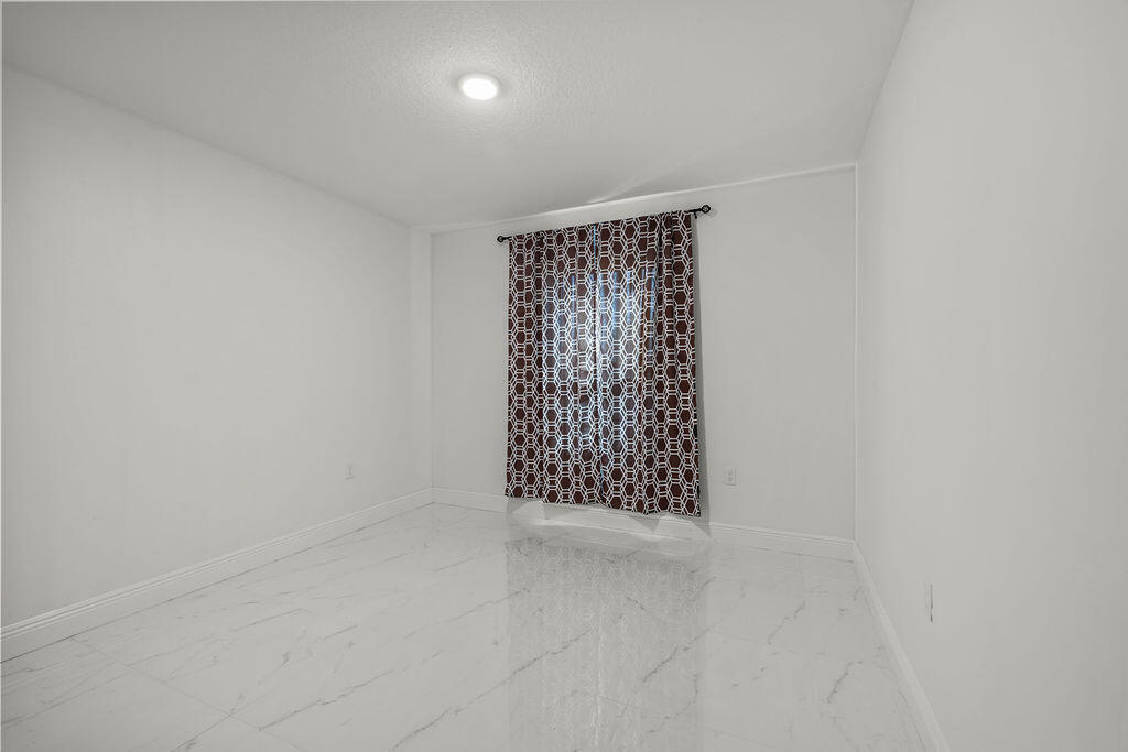 362 Northwest Bayshore Boulevard Port St. Lucie, FL 34983 - Photo 19 of 32 a view of an empty room with a window