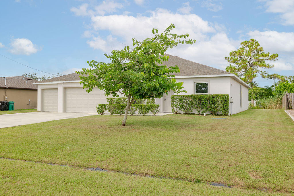 362 Northwest Bayshore Boulevard Port St. Lucie, FL 34983 - Photo 22 of 32 a house that has a tree in front of it