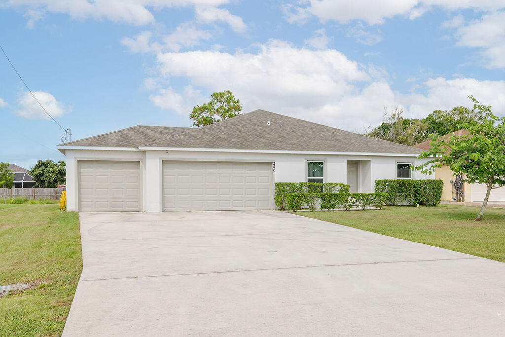 362 Northwest Bayshore Boulevard Port St. Lucie, FL 34983 - Photo 25 of 32 a front view of a house with a garden and yard