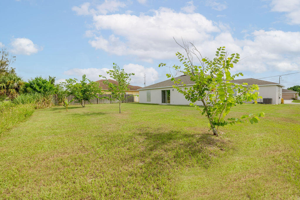 362 Northwest Bayshore Boulevard Port St. Lucie, FL 34983 - Photo 26 of 32 a view of a house with a yard