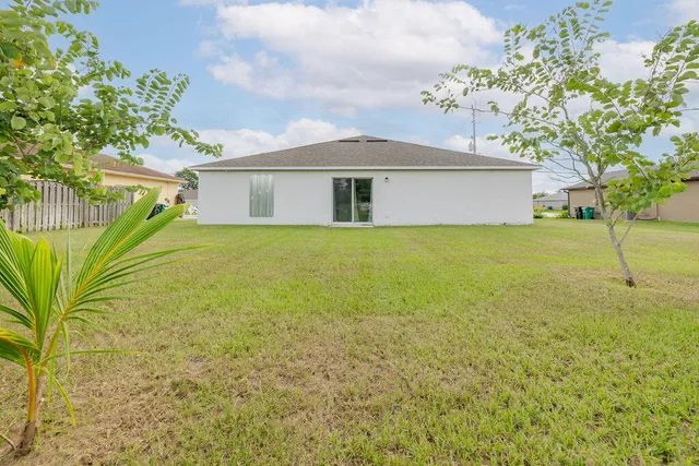 a front view of a house with a garden and yard