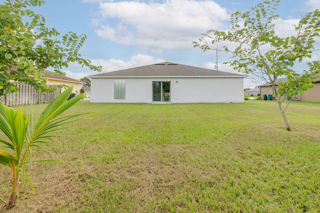 362 Northwest Bayshore Boulevard Port St. Lucie, FL 34983 - Photo 28 of 32 a view of a house with a garden