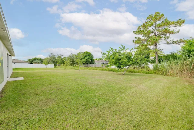 a view of yard with swimming pool and green space