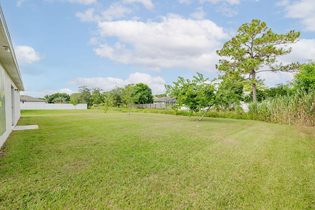 362 Northwest Bayshore Boulevard Port St. Lucie, FL 34983 - Photo 30 of 32 a view of yard with swimming pool and green space